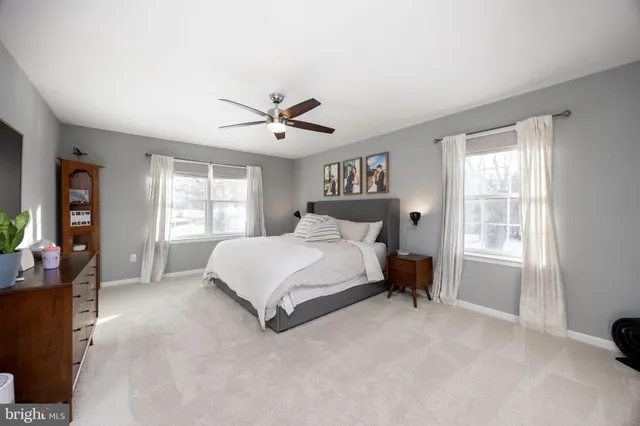a living room with furniture and baby crib