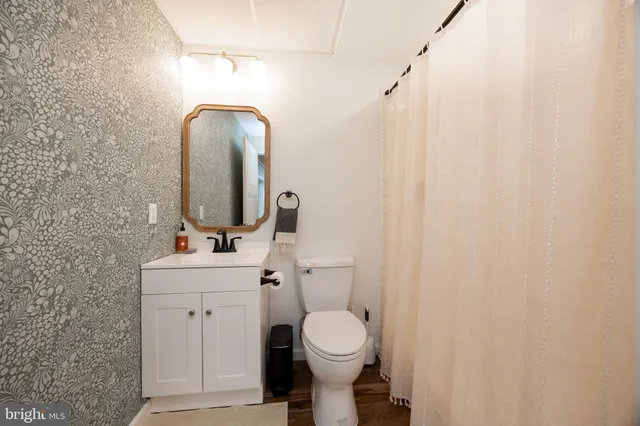 a view of a house with wooden deck and furniture
