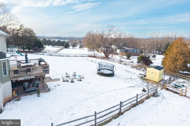 a view of a roof deck with table and chairs couches with wooden floor