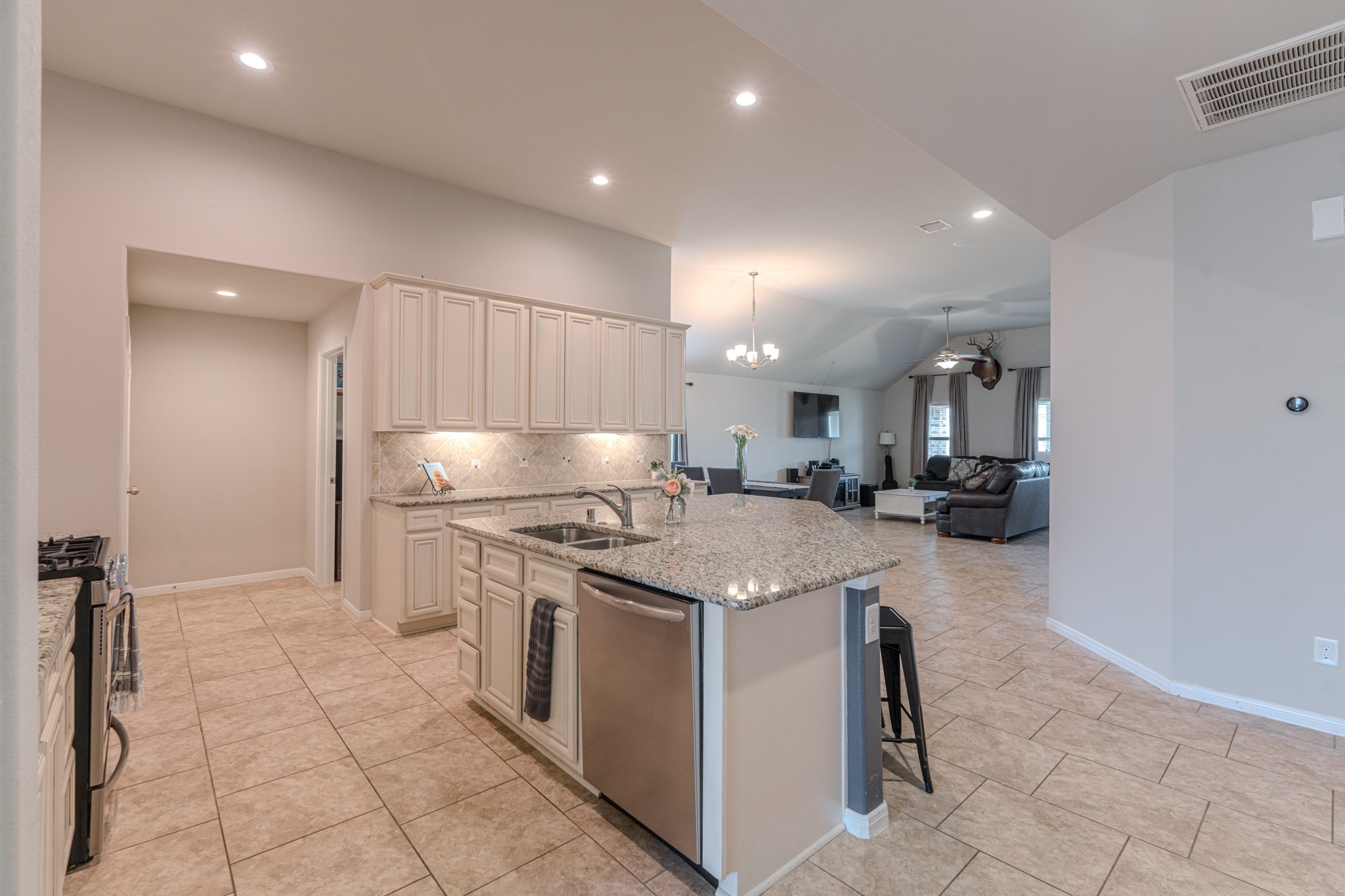 14207 Irvine Rnch Trail Conroe, TX 77384 - Photo 5 of 29 a kitchen with stainless steel appliances granite countertop a sink stove and refrigerator