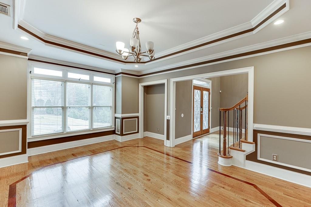 940 Chateau Forest Road Hoschton, GA 30548 - Photo 8 of 87 a view of an empty room with wooden floor and a window