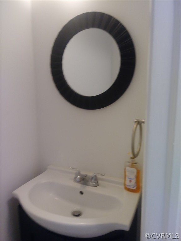 Downstairs half bath with ceramic floor.