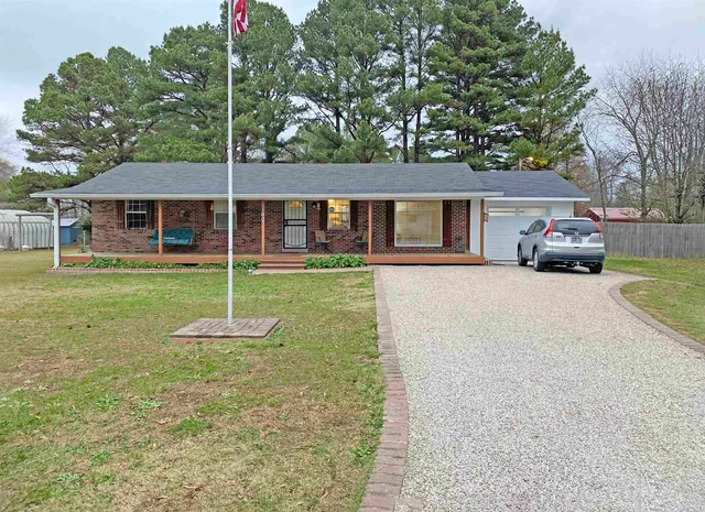 a kitchen with stainless steel appliances granite countertop a dining table chairs refrigerator and sink
