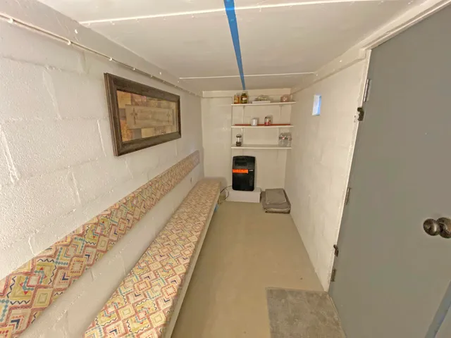 a bedroom with a bed and dresser with mirror