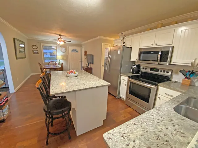 a view of a room with furniture and wooden floor