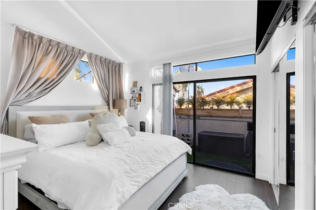 a bedroom with a bed and a large window