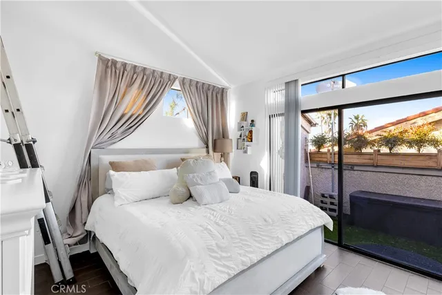 a bedroom with a large bed and a large window