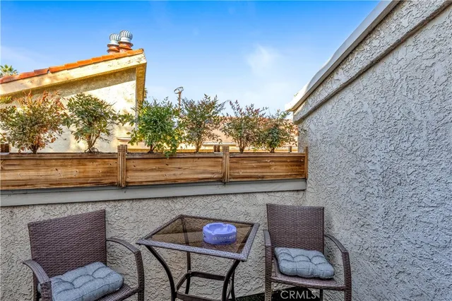 a view of a balcony with chair and wooden floor