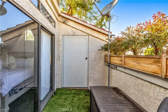 a view of balcony with a table and chairs and potted plants