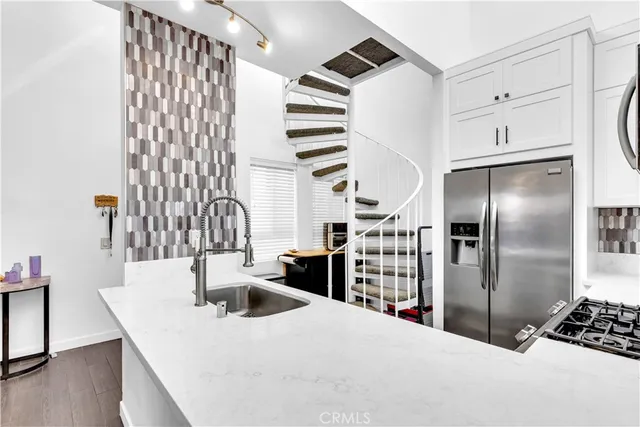 a kitchen with a refrigerator and a sink