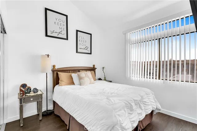 a large bed sitting in a bedroom next to a window