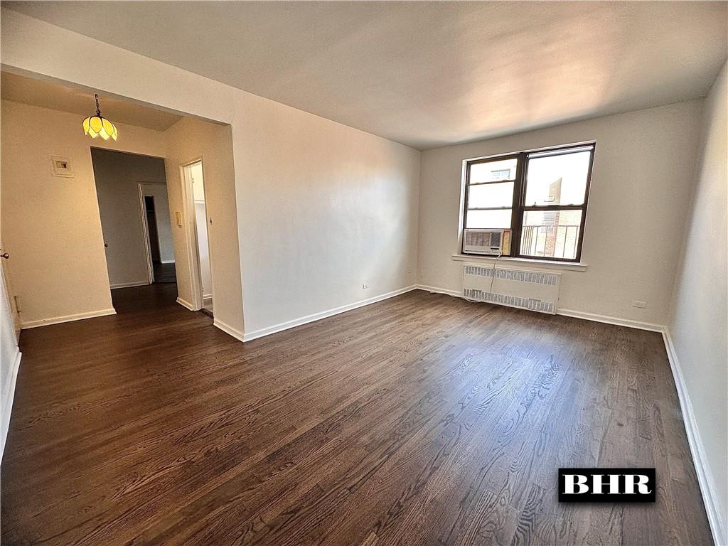 2615 Homecrest Avenue, Unit 6B Brooklyn, NY 11235 - Photo 3 of 17 an empty room with wooden floor and windows