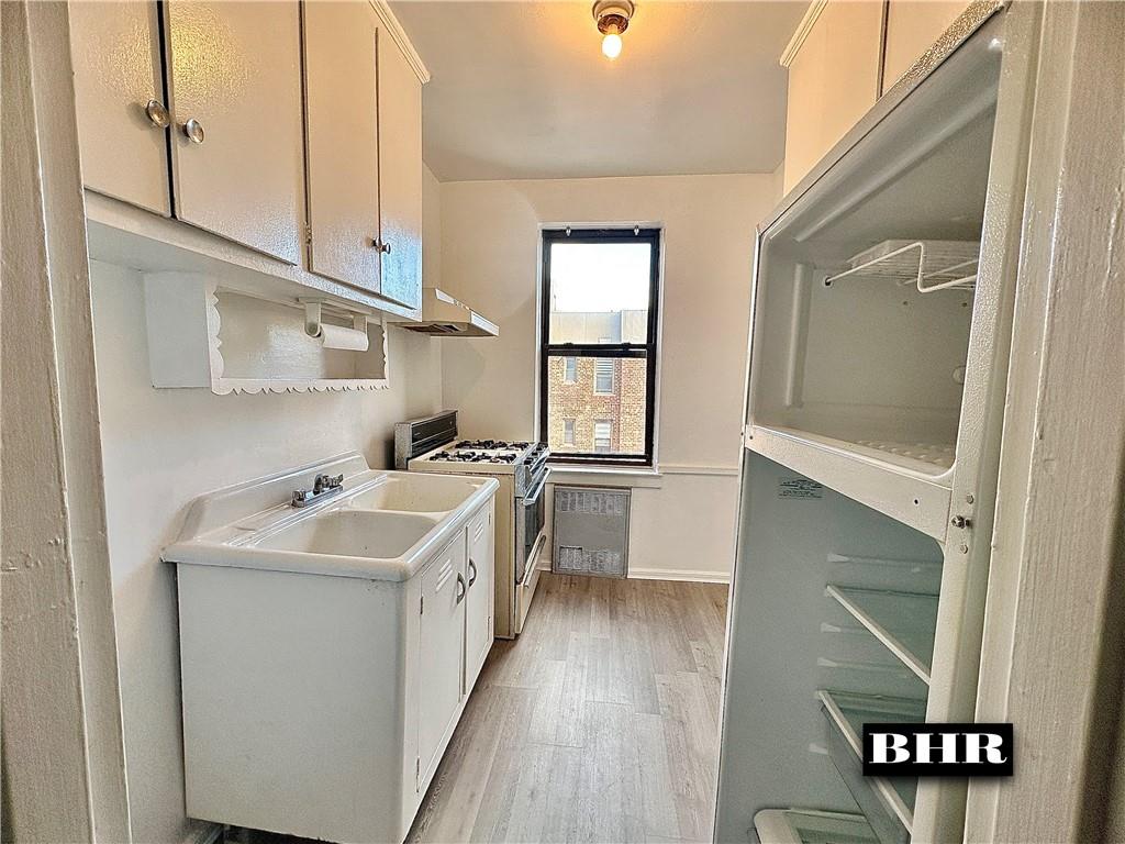 2615 Homecrest Avenue, Unit 6B Brooklyn, NY 11235 - Photo 7 of 17 a kitchen with a sink cabinets and wooden floor