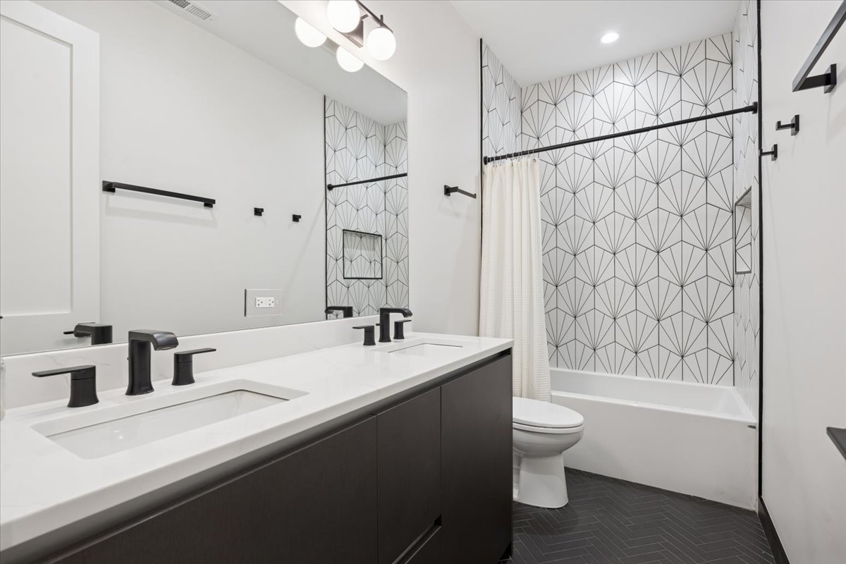 2228 West Belmont Avenue, Unit 2 Chicago, IL 60618 - Photo 16 of 18 a bathroom with a sink a toilet and shower