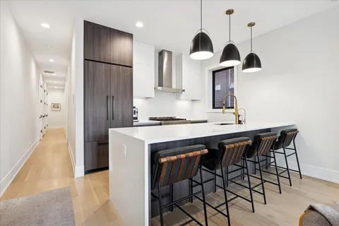 a kitchen with stainless steel appliances granite countertop a sink and a refrigerator