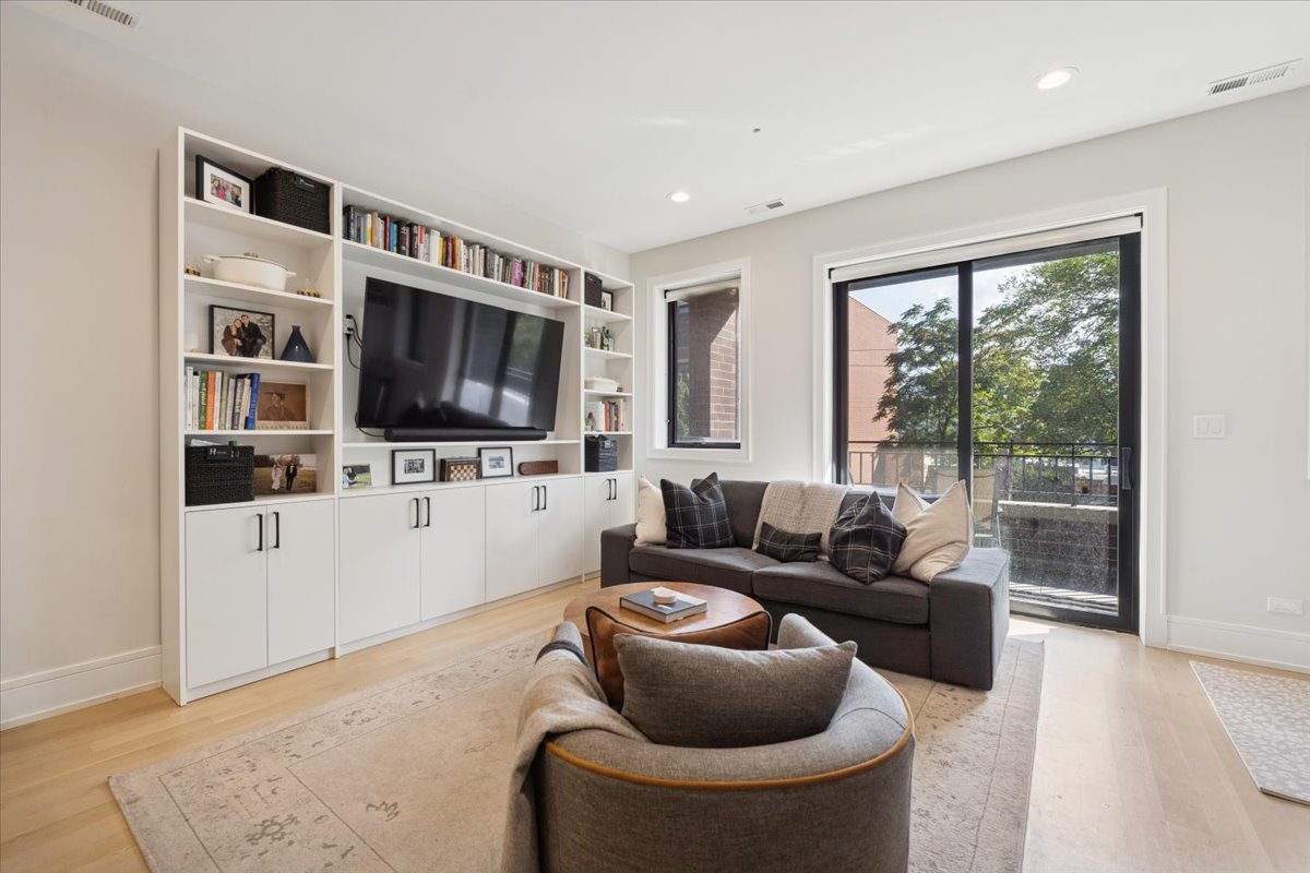 2228 West Belmont Avenue, Unit 2 Chicago, IL 60618 - Photo 8 of 18 a living room with furniture and a flat screen tv