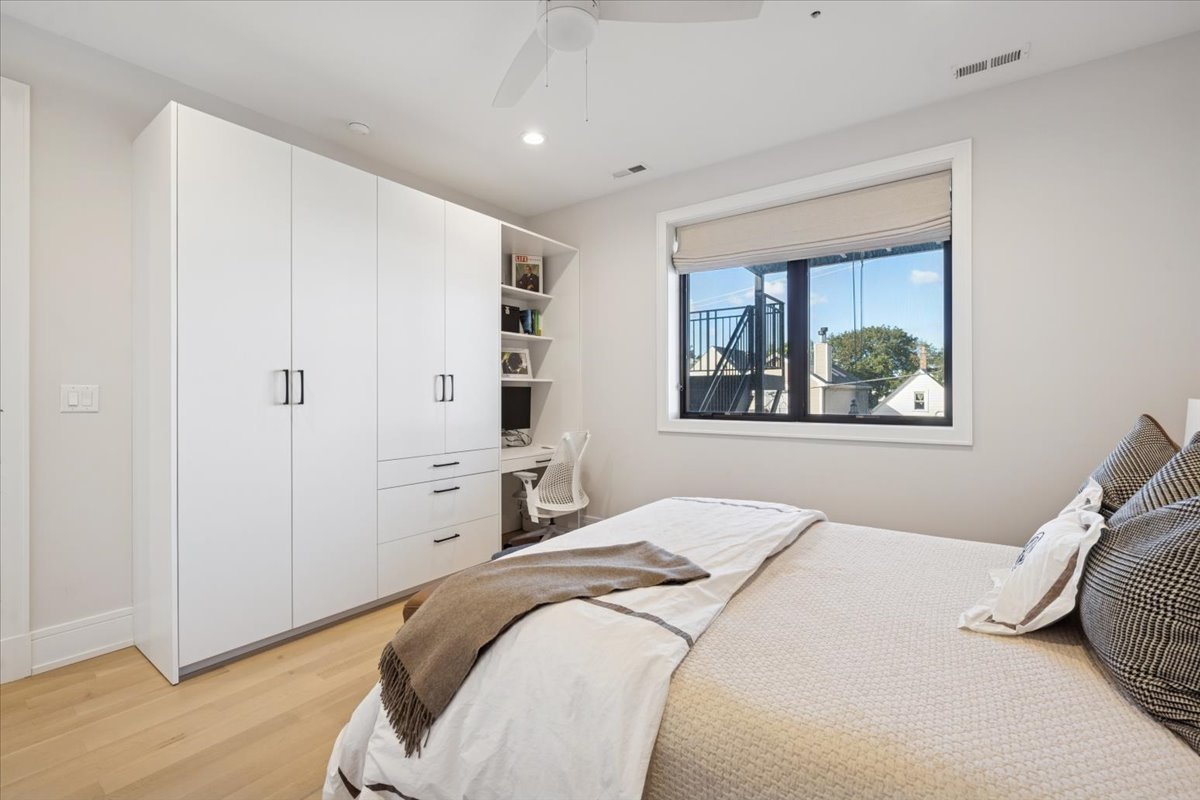 2228 West Belmont Avenue, Unit 2 Chicago, IL 60618 - Photo 10 of 18 a bedroom with a bed and a painting on the wall