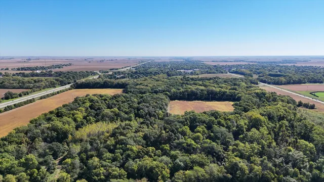 an aerial view of a house with a yard and lake view