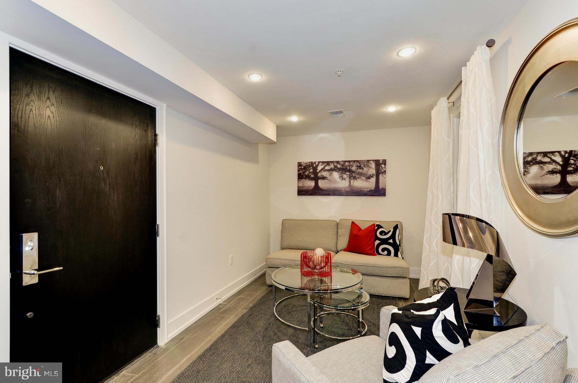 2515 17th Street Northwest, Unit 1 Washington, DC 20009 - Photo 2 of 12 a living room with furniture and a window