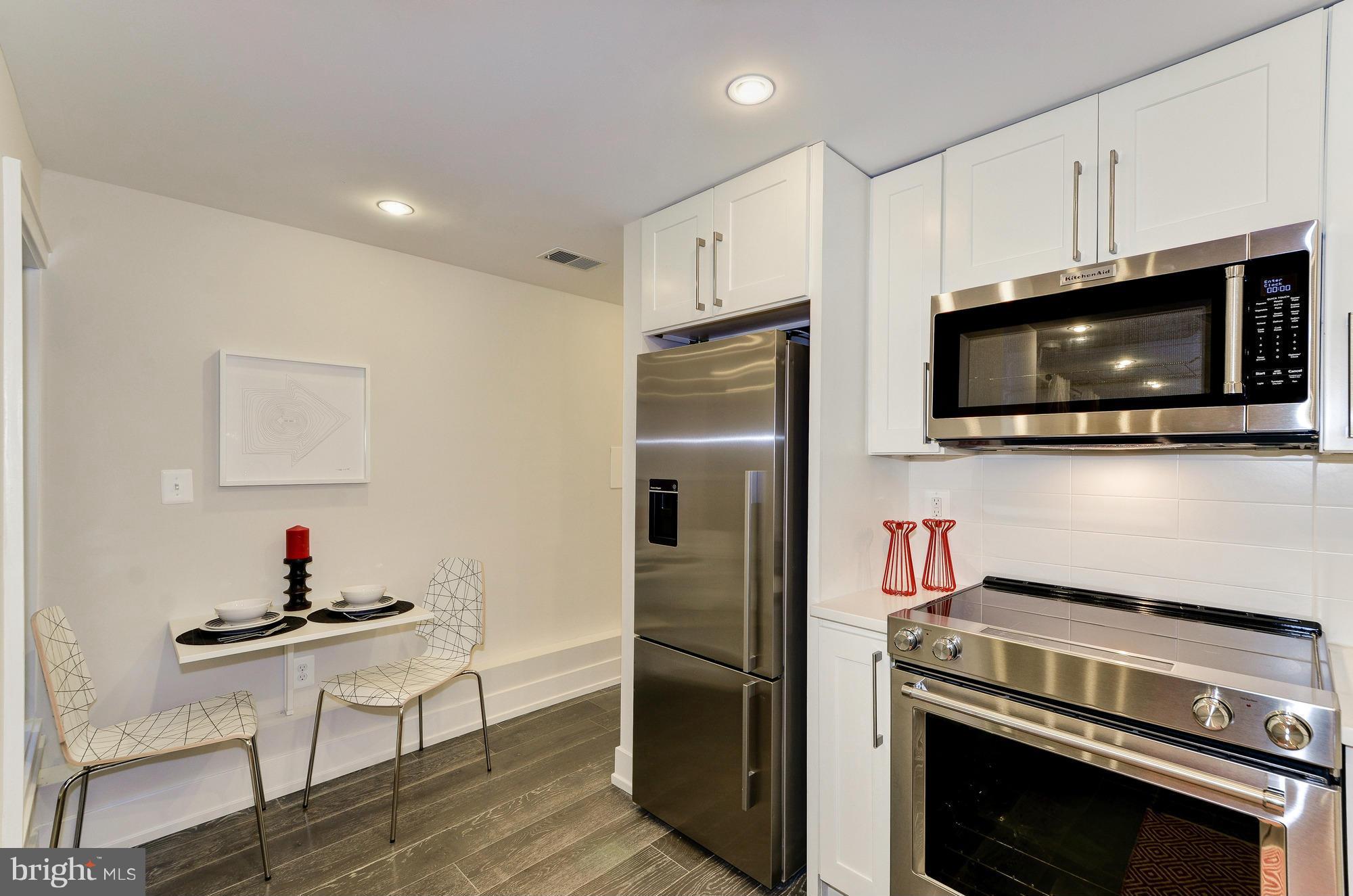 2515 17th Street Northwest, Unit 1 Washington, DC 20009 - Photo 4 of 12 a kitchen with a refrigerator stove and microwave