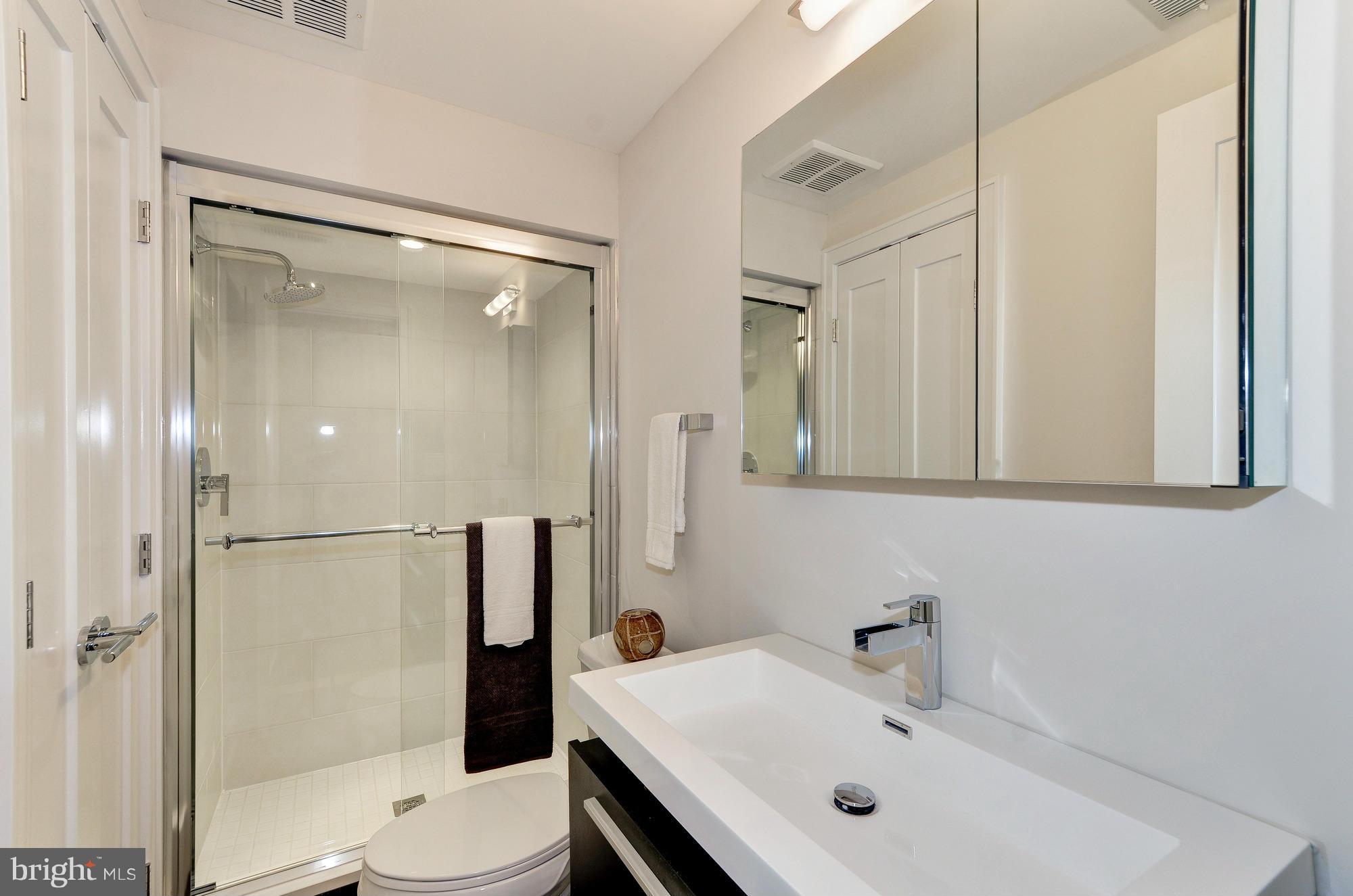 2515 17th Street Northwest, Unit 1 Washington, DC 20009 - Photo 5 of 12 a bathroom with a sink mirror shower and toilet