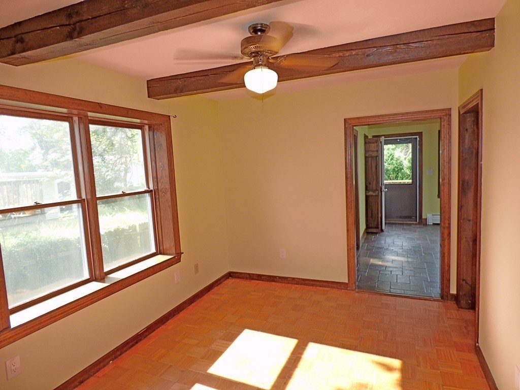 327 Union Street Randolph, MA 02368 - Photo 13 of 29 a view of empty room with wooden floor and fan