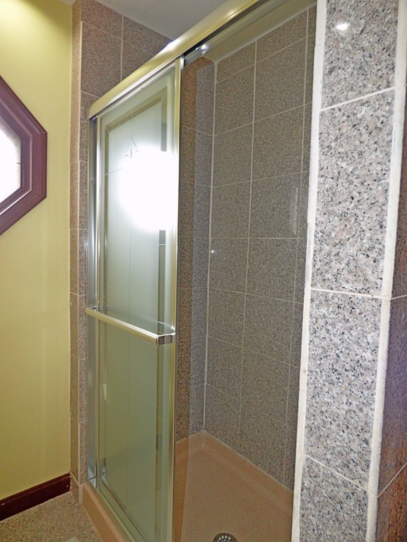 327 Union Street Randolph, MA 02368 - Photo 22 of 29 a bathroom with a glass shower door