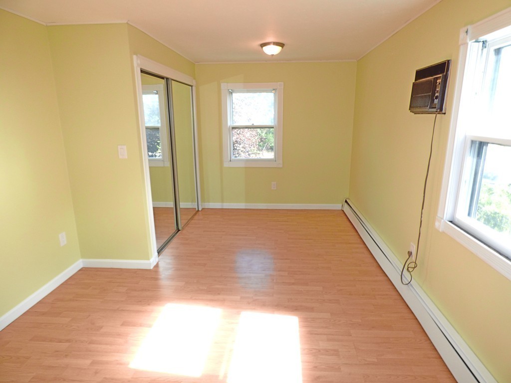327 Union Street Randolph, MA 02368 - Photo 23 of 29 a view of an empty room with wooden floor and a window
