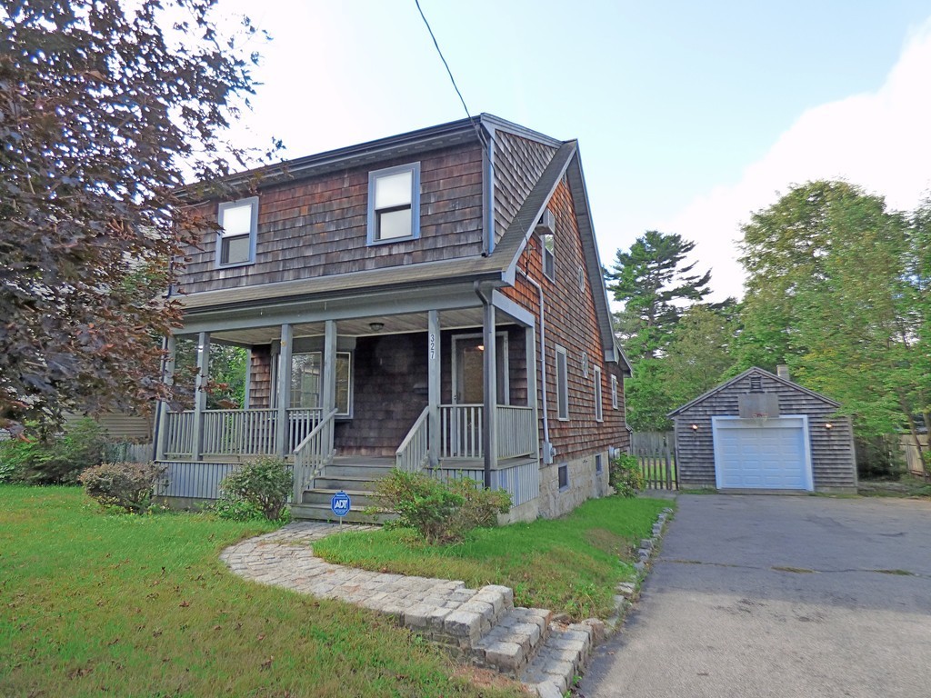 327 Union Street Randolph, MA 02368 - Photo 3 of 29 a front view of a house with a yard and garage