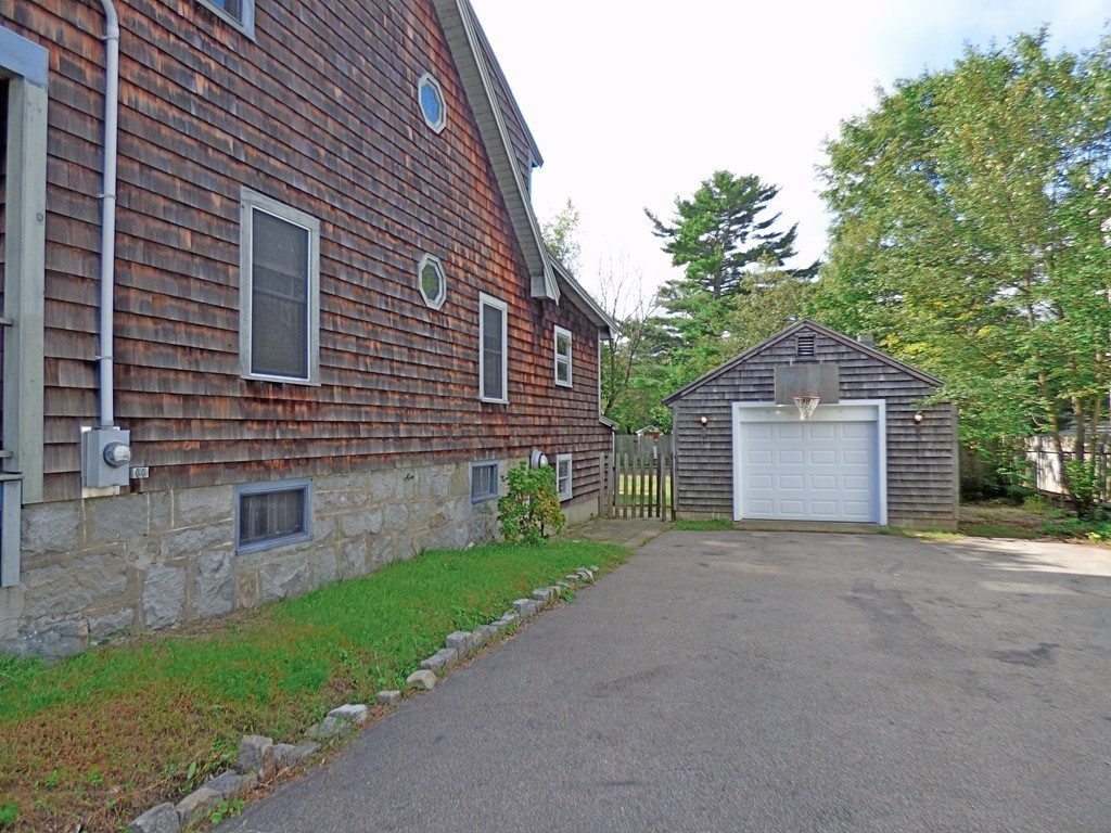 327 Union Street Randolph, MA 02368 - Photo 4 of 29 a front view of a house with a yard and garage