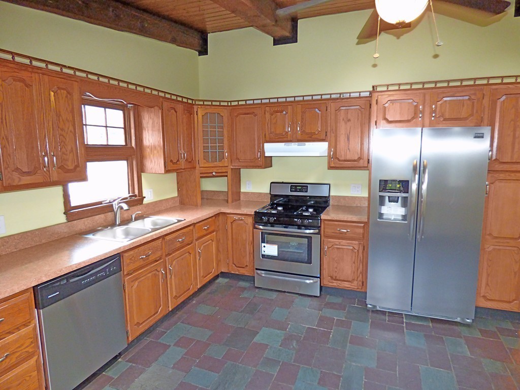 327 Union Street Randolph, MA 02368 - Photo 9 of 29 a kitchen with stainless steel appliances and cabinets