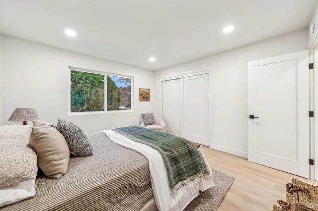 a bedroom with a bed and a window