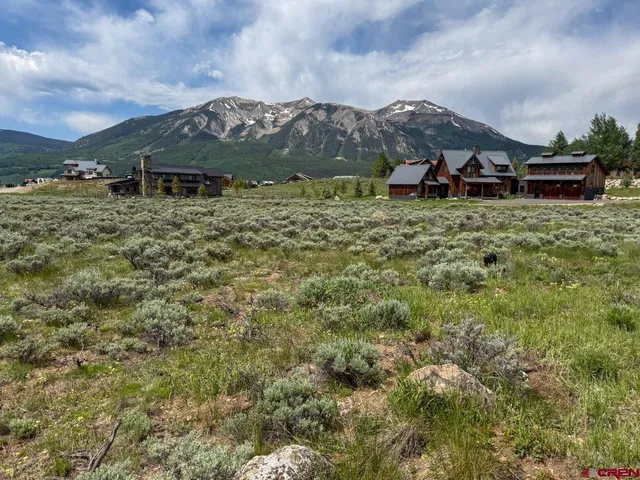 a view of a town with mountains in the background