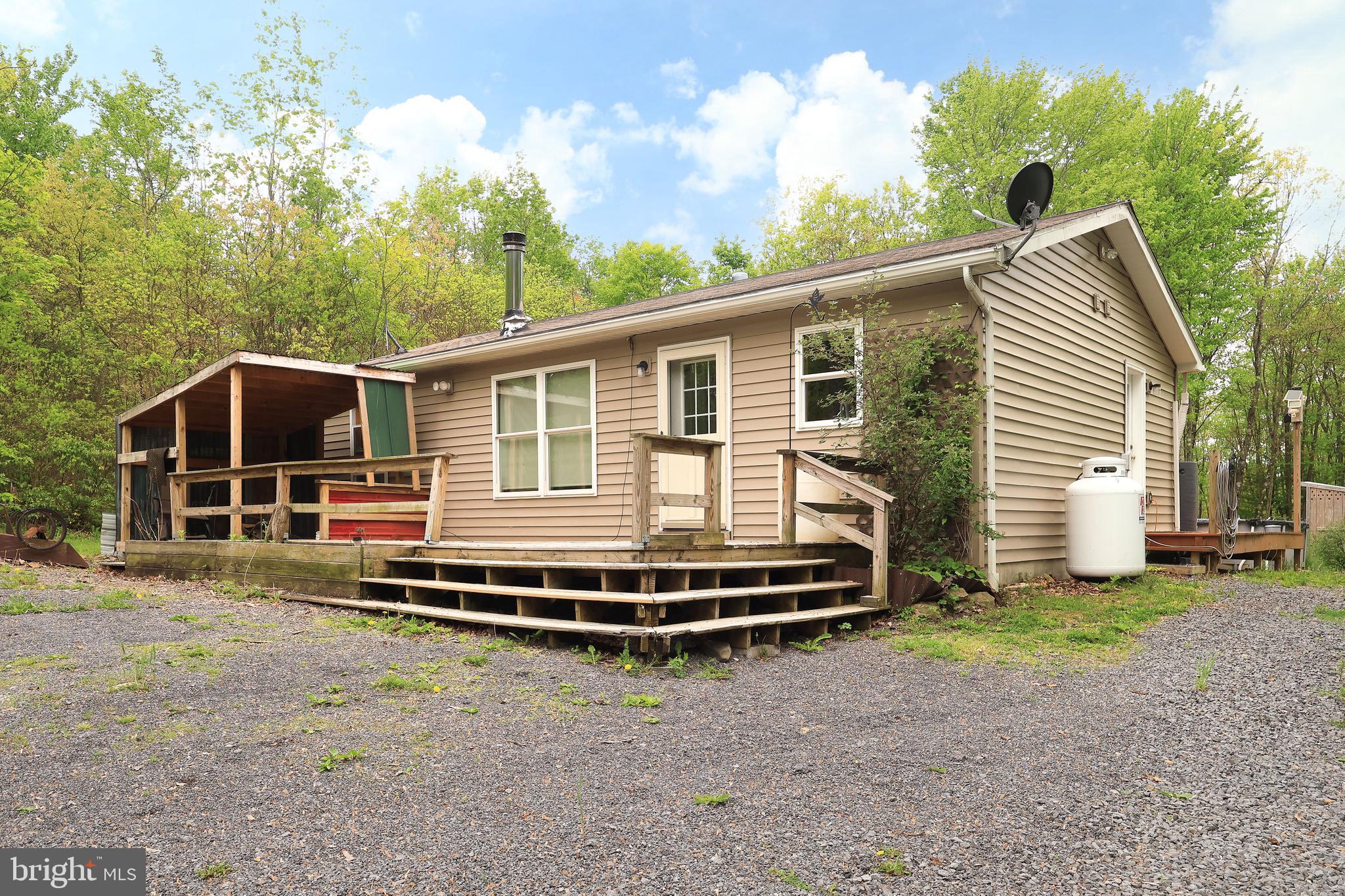 358 Buckridge Road Howard, PA 16841 - Photo 2 of 40 a front view of a house with a garden