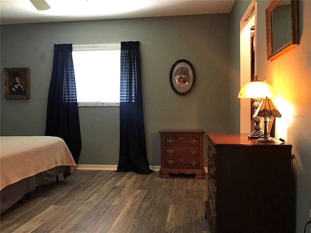11879 Southwest 137th Loop Dunnellon, FL 34432 - Photo 15 of 37 a bedroom with a bed and a dresser next to a window