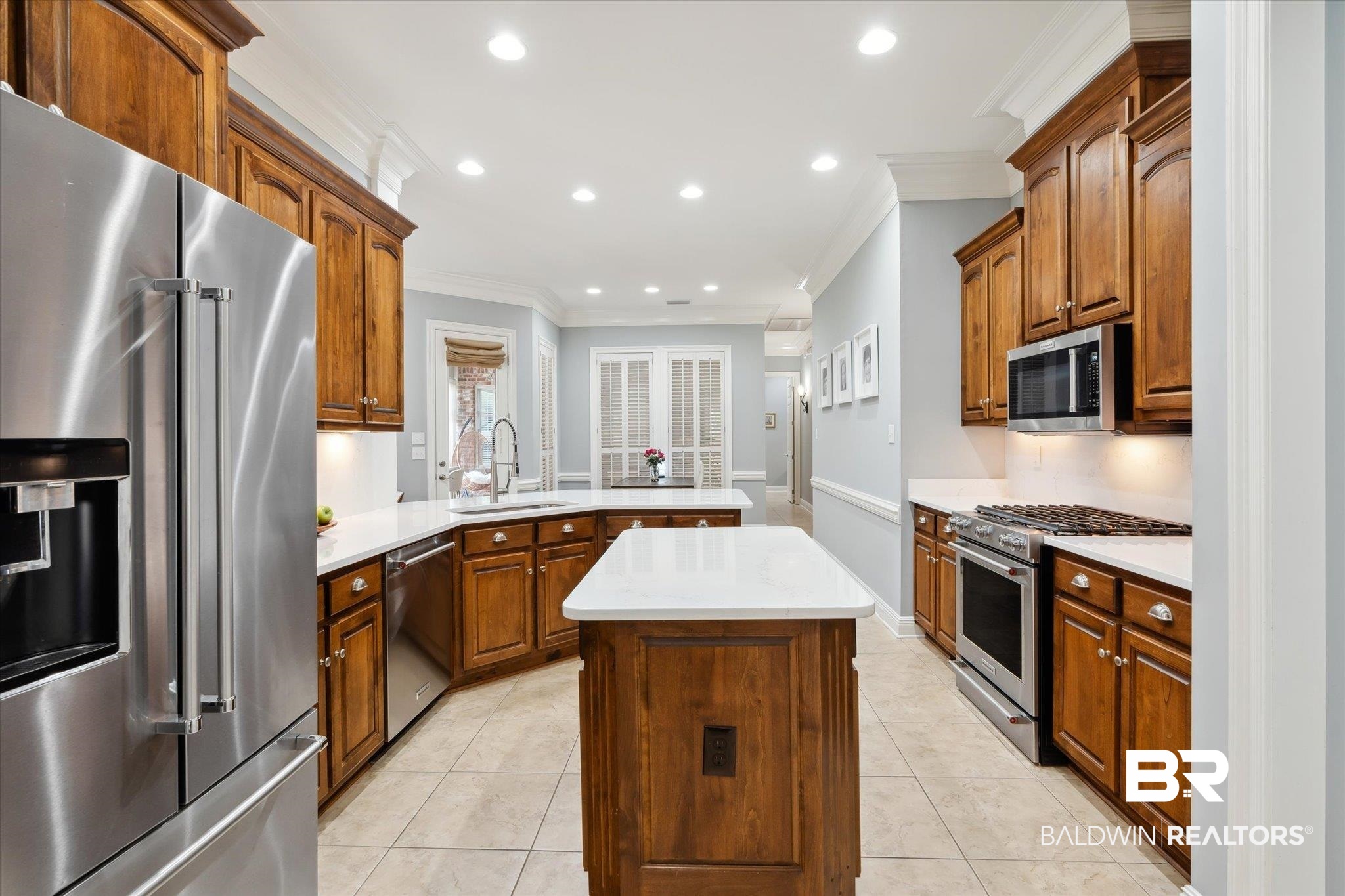 804 Country Club Road Mobile, AL 36609 - Photo 10 of 63 Kitchen featuring sink, light tile patterned flooring, a kitchen island, and stainless steel appliances