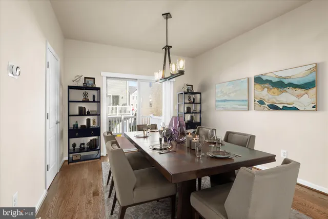 a view of a dining room with a table and chairs