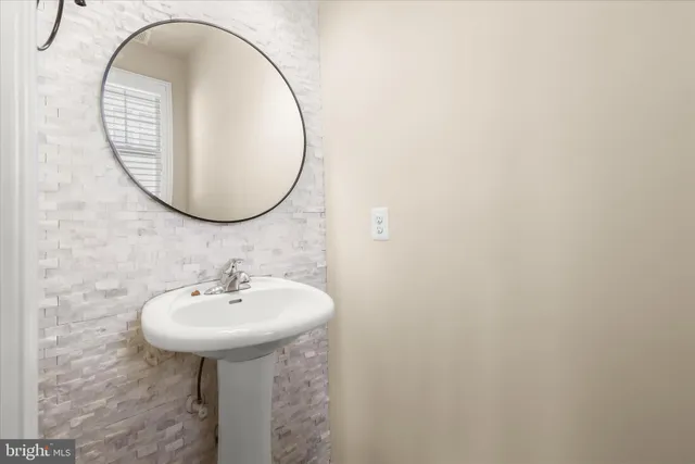 an empty room with a window and a ceiling fan