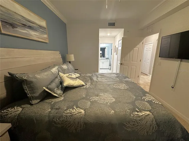 a bed sitting in a bedroom next to a window