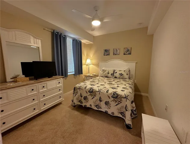 a bedroom with a bed and flat screen tv