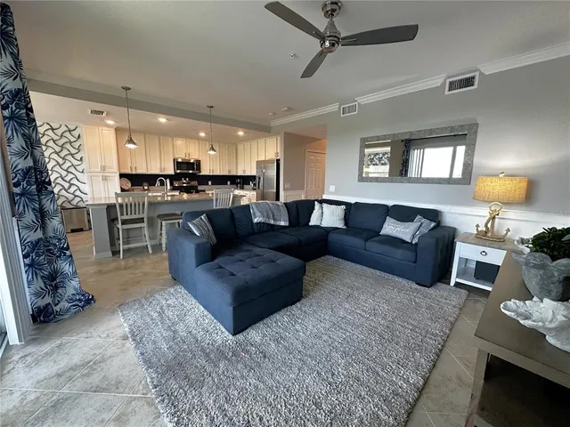 a living room with furniture hard wood floor and a window