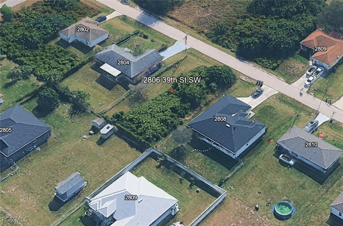 2806 39th Street Southwest Lehigh Acres, FL 33976 - Photo 4 of 5 an aerial view of a house with a yard