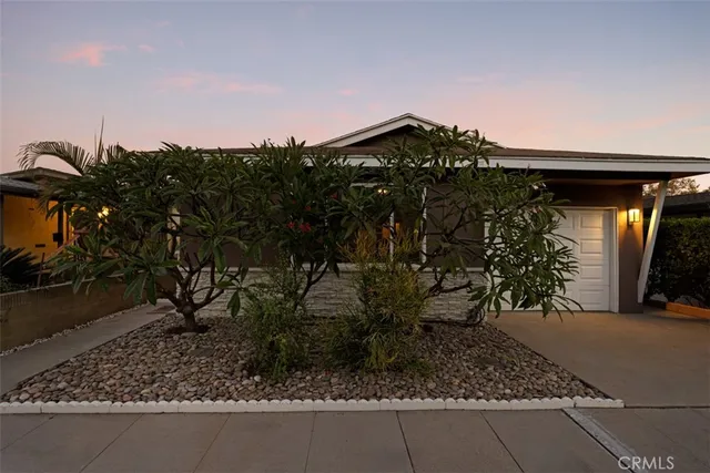 a view of a house with a yard and plants