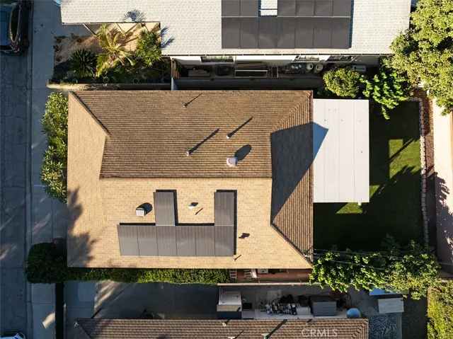 an aerial view of a house with a yard