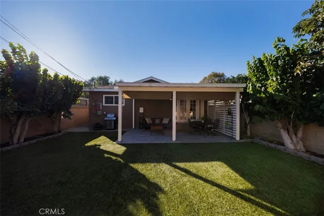 a view of a porch with furniture and a backyard