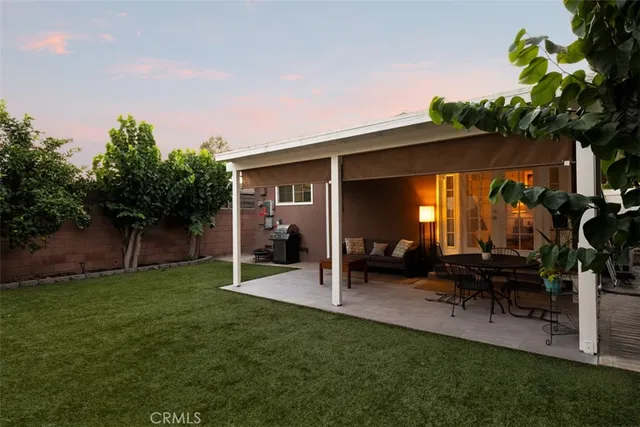 a view of a patio with table and chairs and potted plants