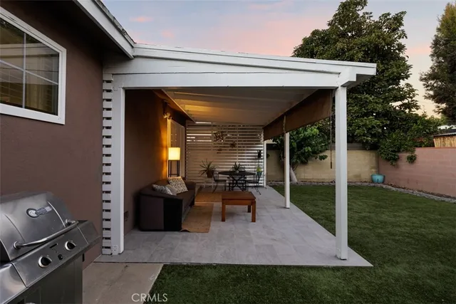a view of a house with a backyard and a bench