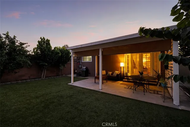 a view of a chairs and table in patio with a yard