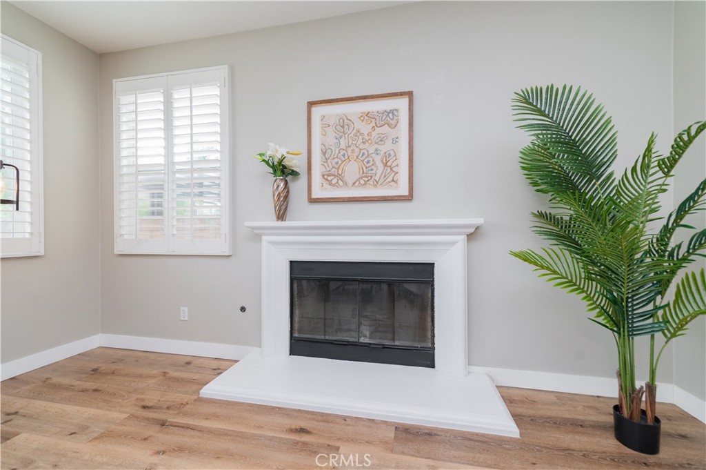 14236 Pointer Loop Eastvale, CA 92880 - Photo 11 of 38 a living room with a fireplace and potted plants