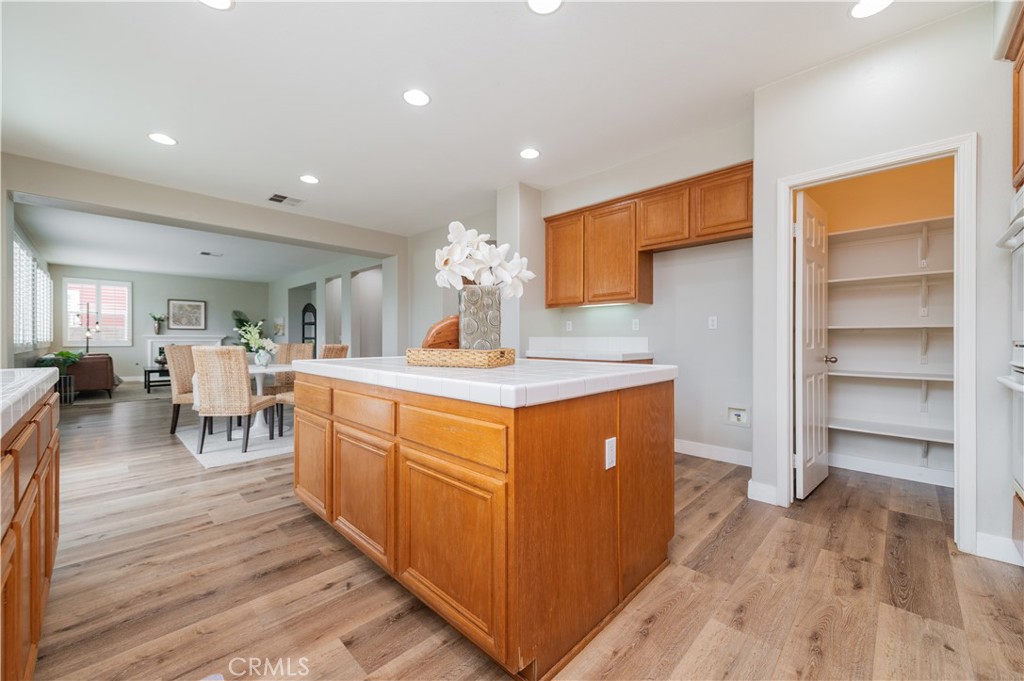 14236 Pointer Loop Eastvale, CA 92880 - Photo 15 of 38 a kitchen with stainless steel appliances granite countertop a stove and a wooden floors